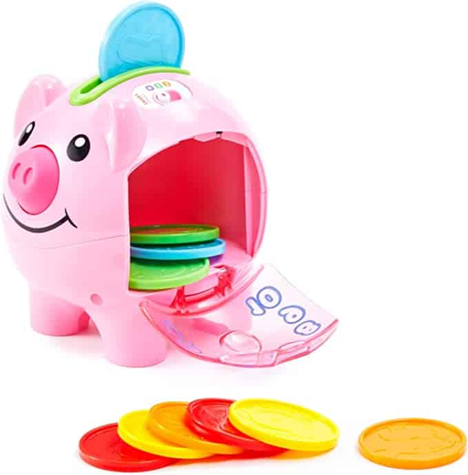 Electronic counting piggy bank made of hard pink plastic with on side open to show where the different color coins go.