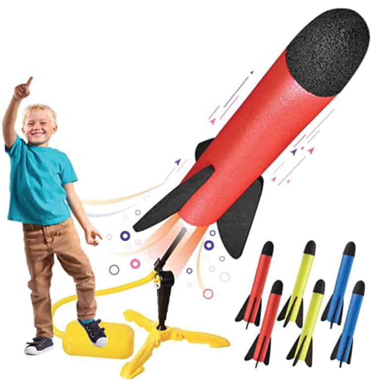 Child stepping on a soft plastic box attached to a tube that launches a foam rocket when the box is stomped on.