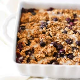 Blueberry baked oatmeal in a white baking dish ready to serve.
