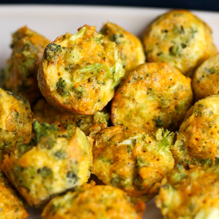A pile of broccoli cheddar bites on a white plate