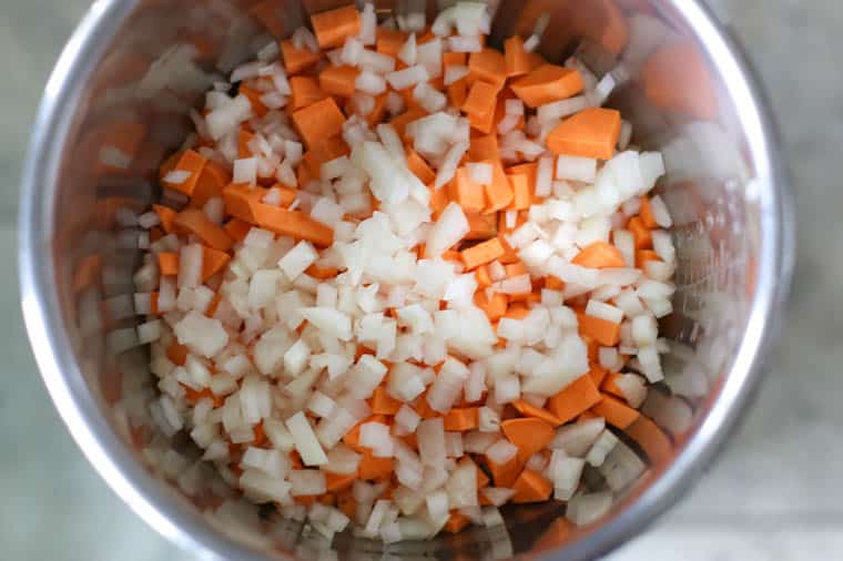 Diced sweet potato and onions in an instant pot insert. 