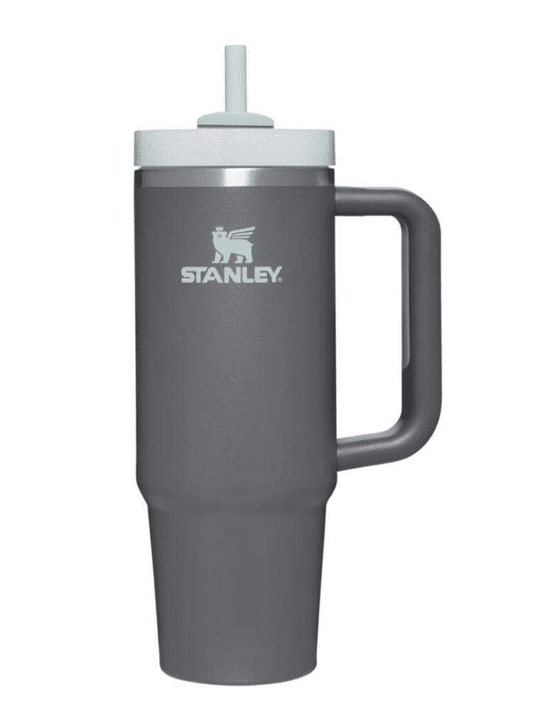 A dark gray Stanley mug with white lid and straw.