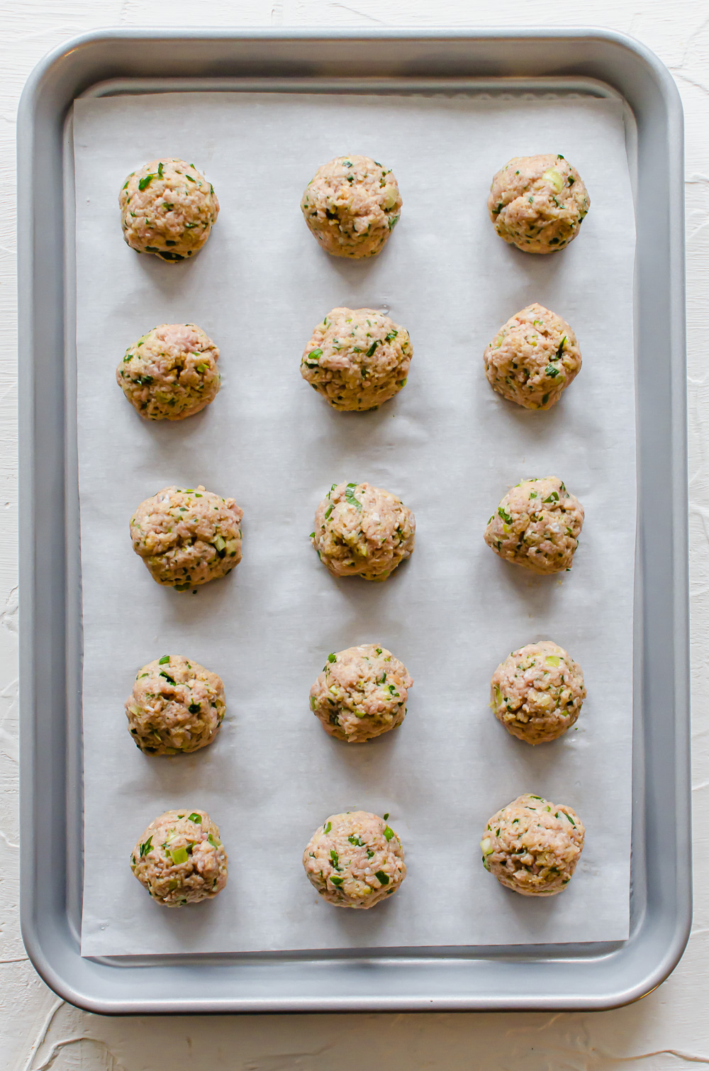 overhead process shot of turkey meatballs before going in the oven