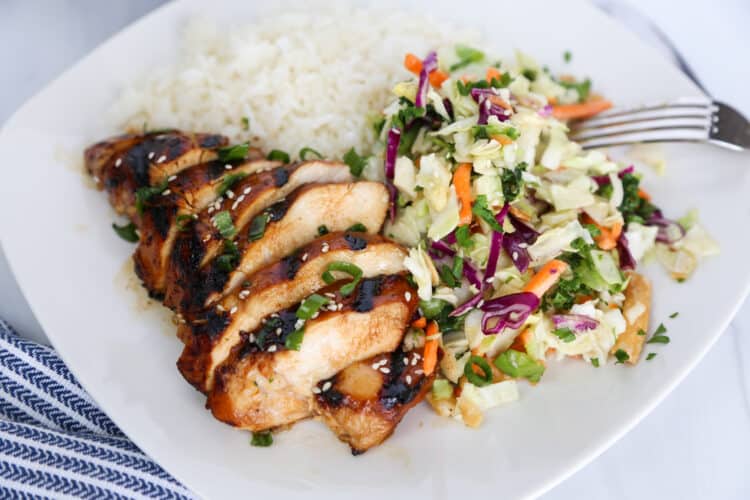 asian chicken sliced with asian slaw and rice