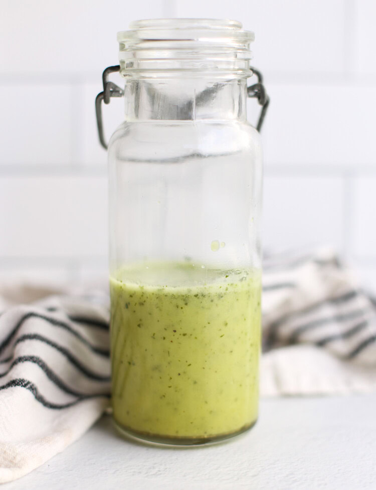 Cilantro Lime Vinaigrette in a glass jar sitting on a counter.