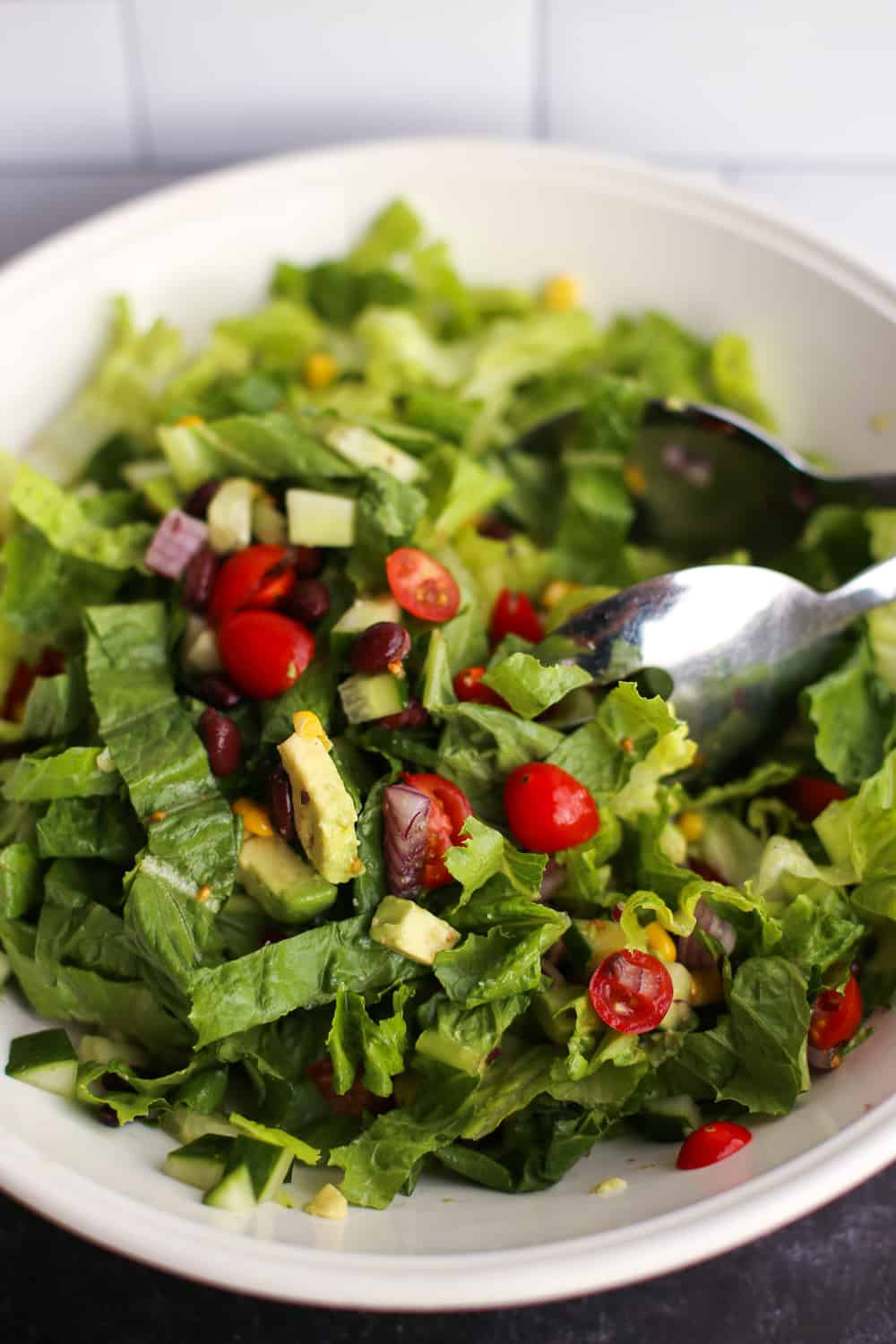 A tossed Mexican Chopped Salad served in a white bowl.