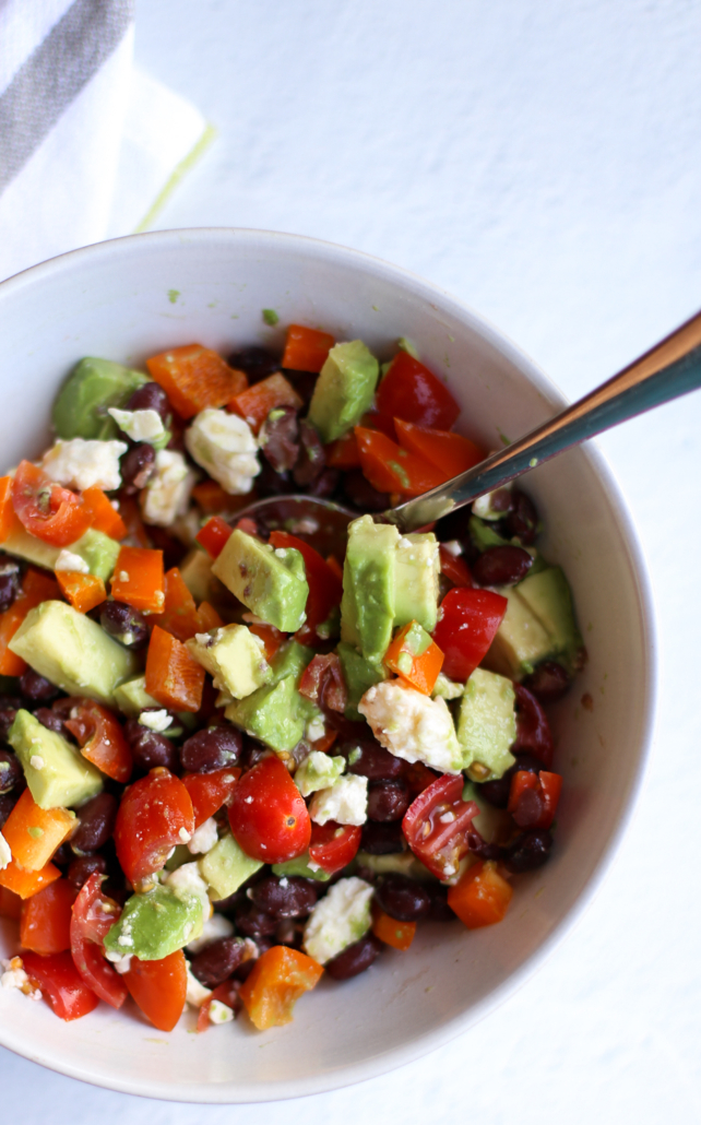 protein bowl with avocado, tomato, feta, peppers, and black beans 