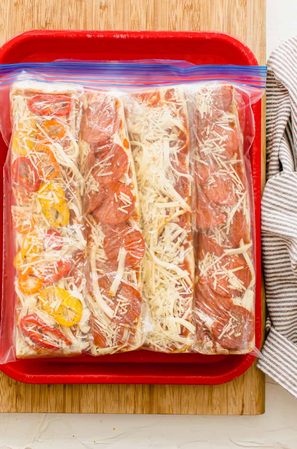 Pizza bread prior to baking in a freezer bag.