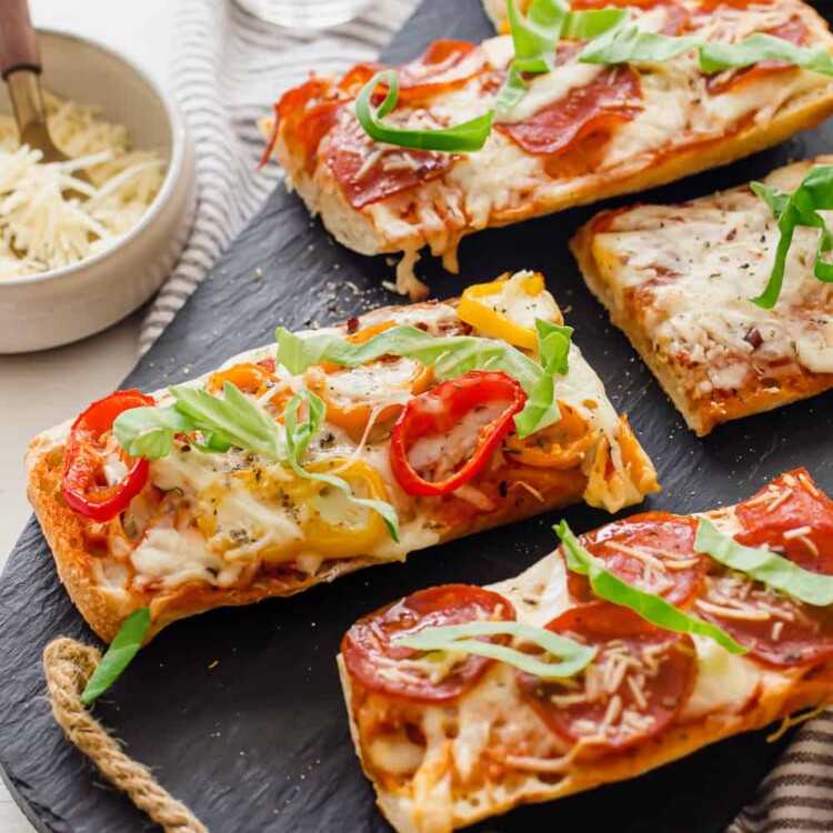 Pizza bread baked and sitting on a gray slate serving platter.