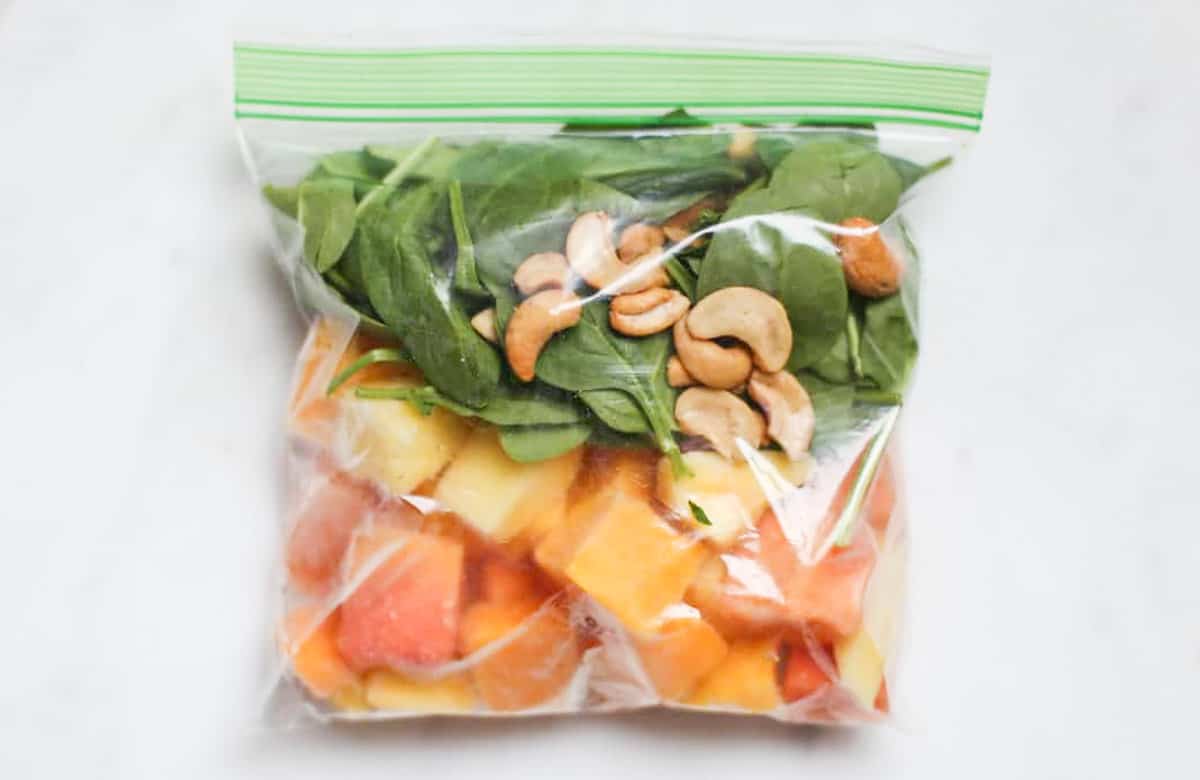 Tropical smoothie ingredients packages as a freezer smoothie pack in a ziplock bag. 