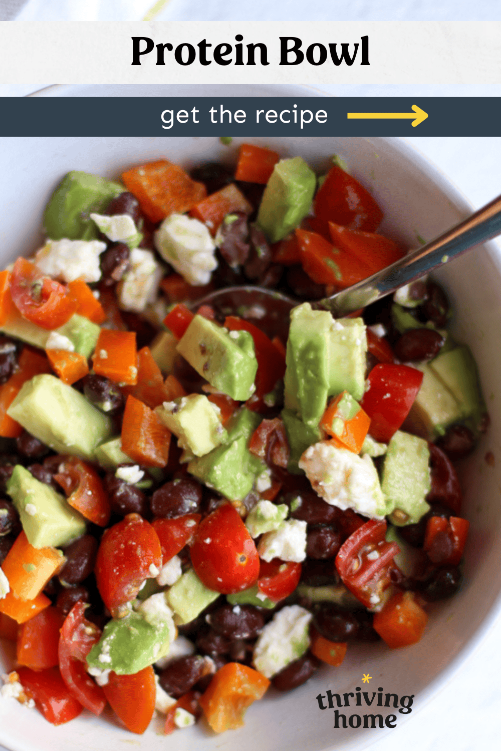 Bowl with black beans, feta cheese, avocado chunks, and chopped red peppers.