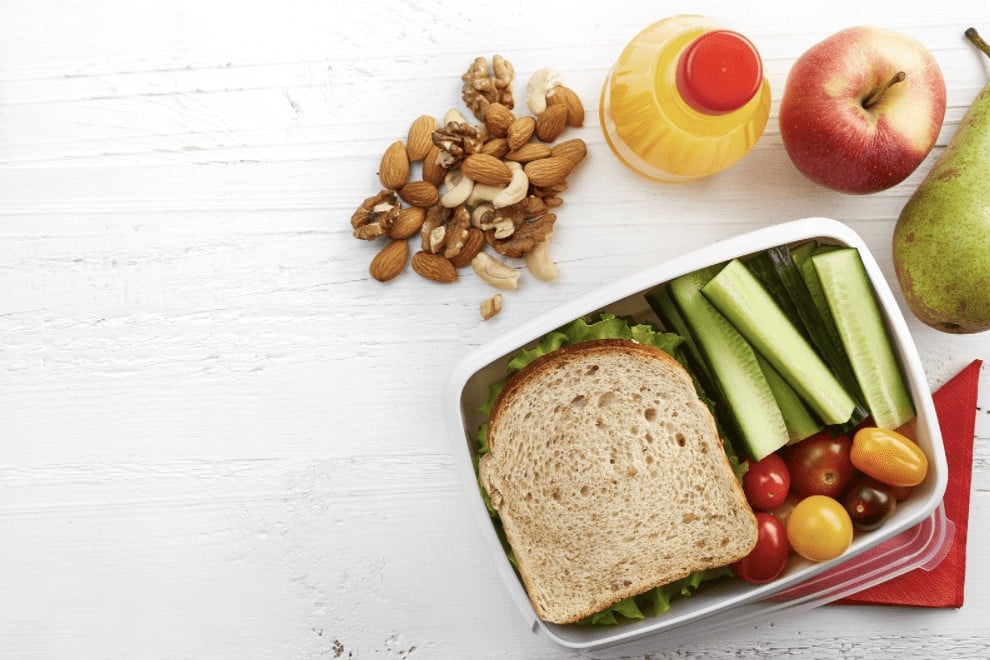 Packed lunch idea for kids: nuts, fruits, veggies, and a sandwich