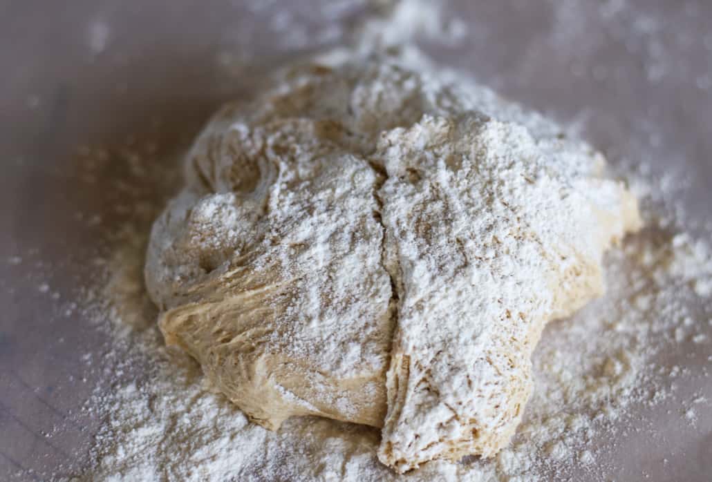 Dough for whole wheat pita bread with flour sprinkled on top