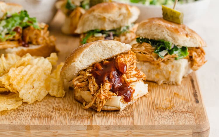 BBQ chicken sliders on a cutting board.