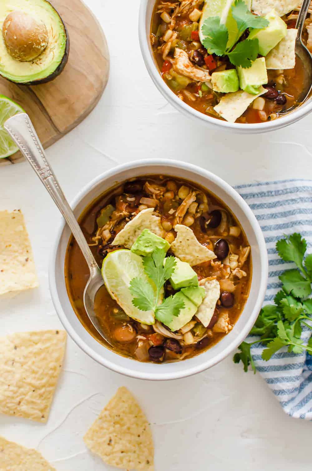 Chicken taco soup in white bowls.