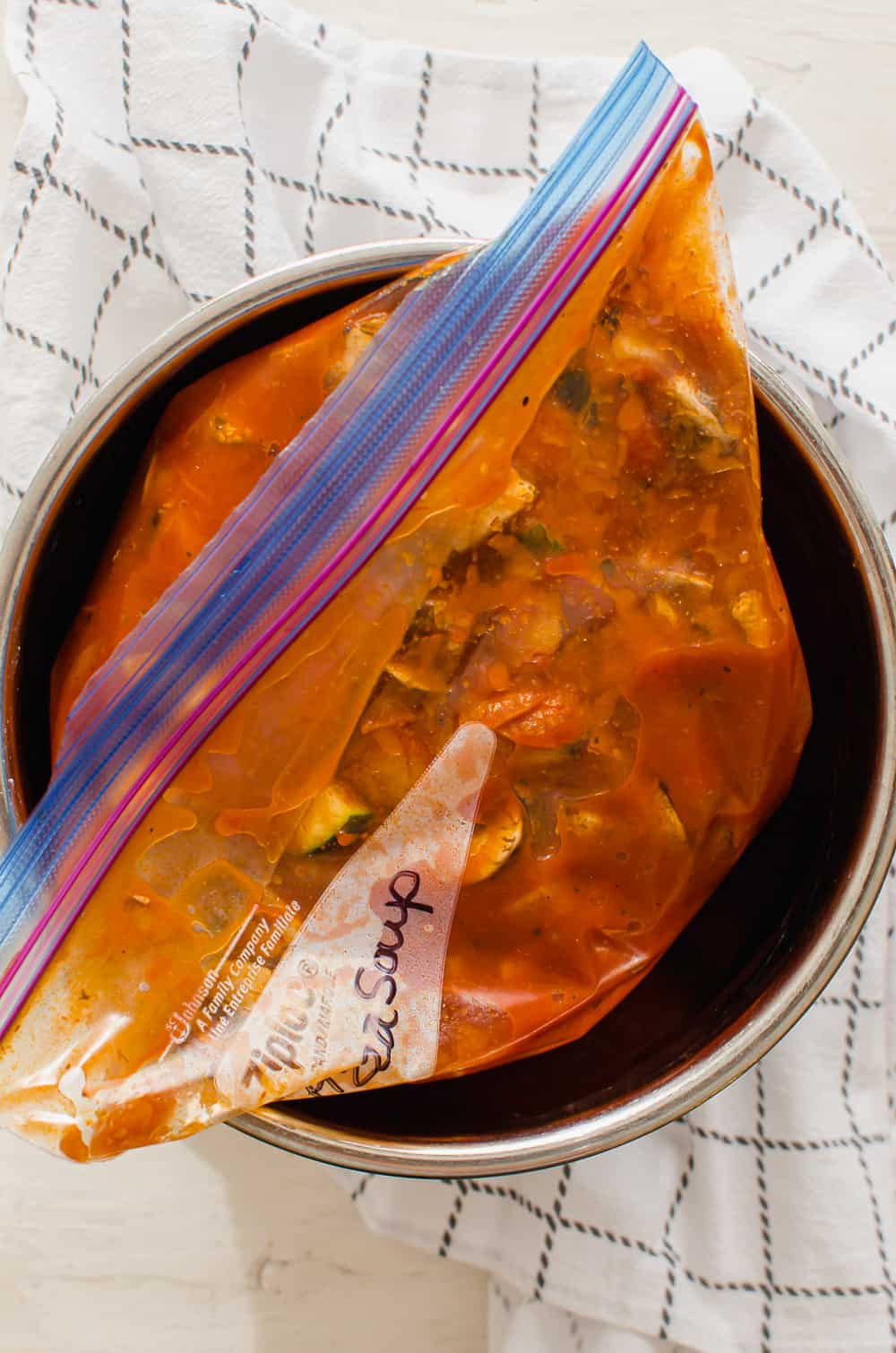 Pizza soup in a freezer bag in an Instant Pot insert.