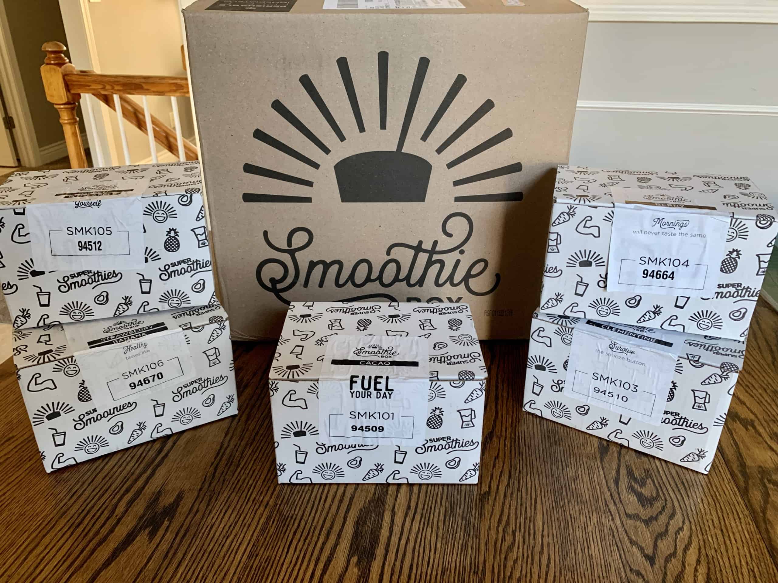 A big SmoothieBox with smaller boxes of the frozen smoothie pouches from SmoothieBox.