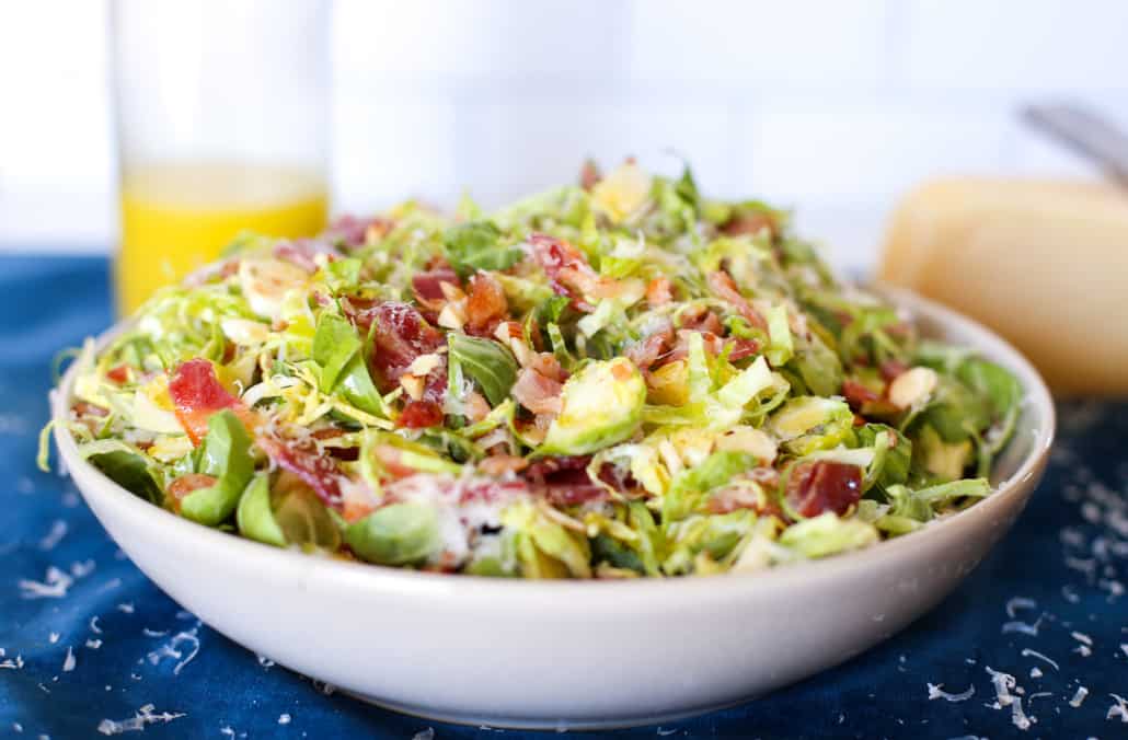 Shaved Brussels Sprout Salad with bacon in a white bowl