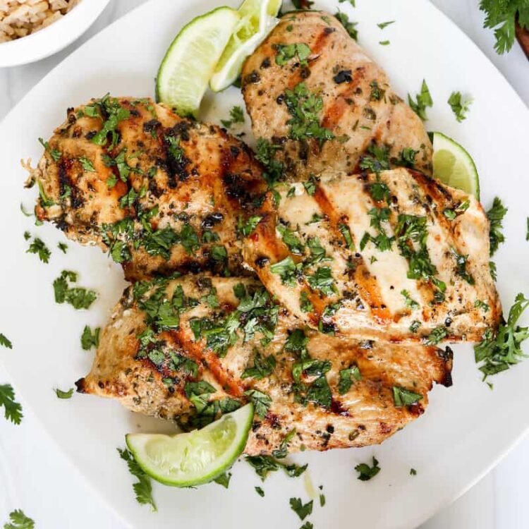 Cilantro lime grilled chicken breasts on a serving platter.