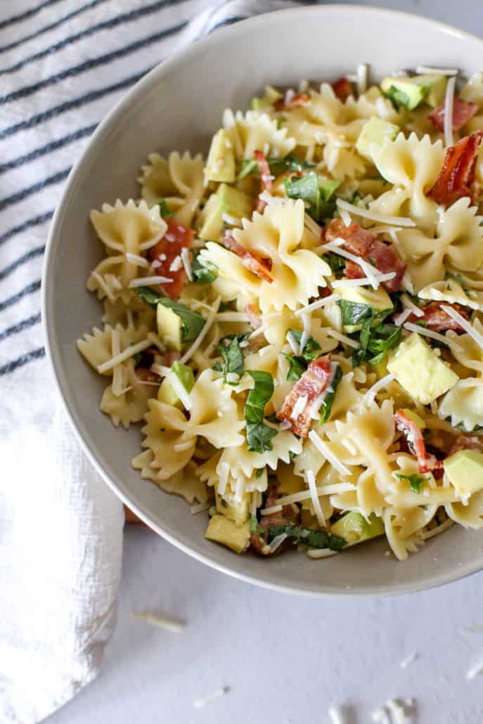 Avocado past with basil and bacon in a white bowl