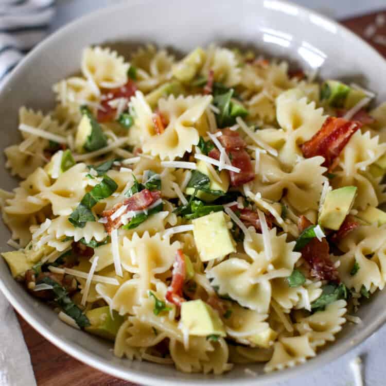 Bowl of avocado, basil and bacon pasta.