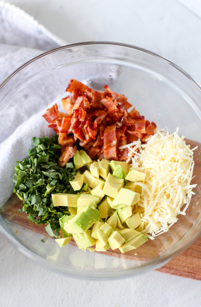 Ingredients for avocado pasta in a glass bowl