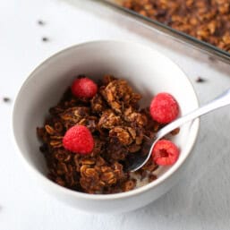 Brownie baked oatmeal in a bowl with raspberries on top.