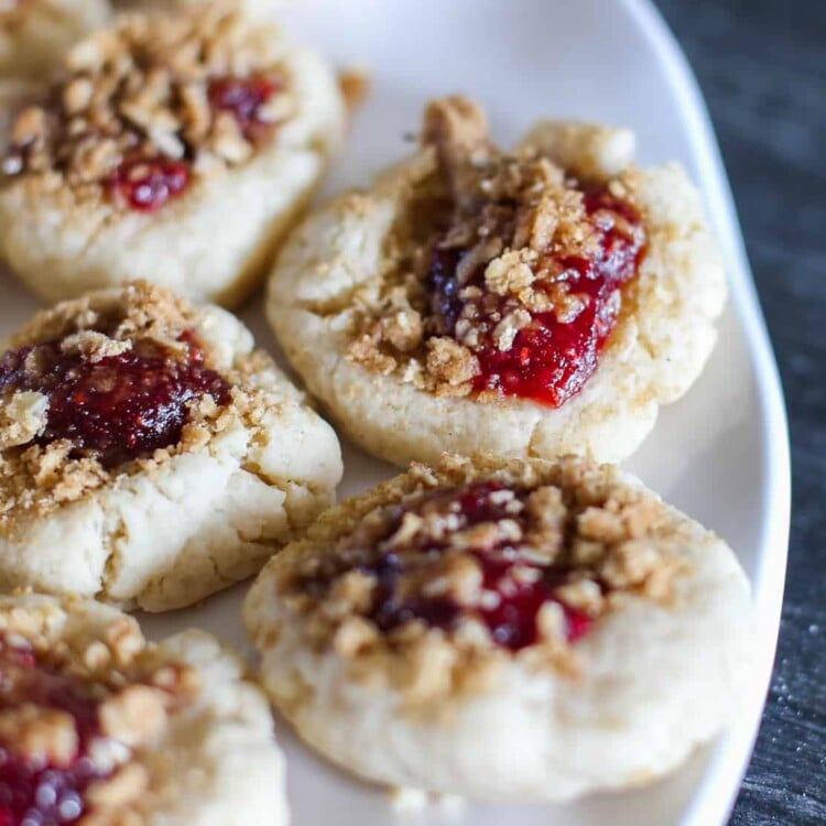 Raspberry crumble cookies on a white platter.