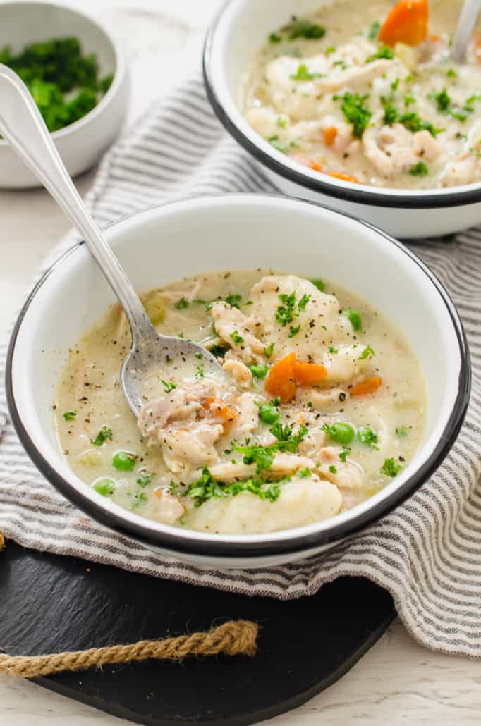 angle shot of two bowls of chicken and dumplings