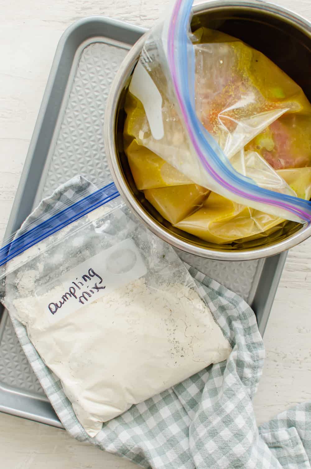 Chicken and dumplings freezer meal in a gallon-size bag inside the pot of an Instant Pot to freeze in a circle.