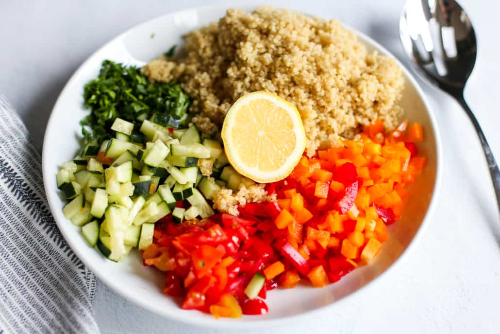 ingredients for quinoa tabbouleh in a big serving bowl