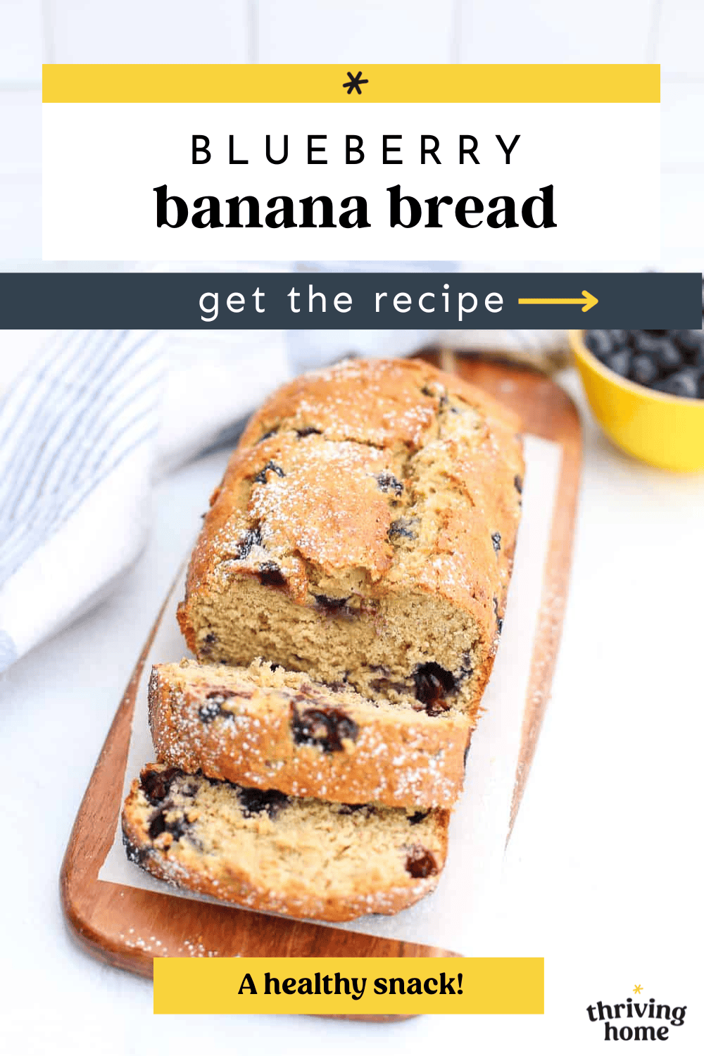 A loaf of blueberry banana bread partially sliced on a wooden cutting board.