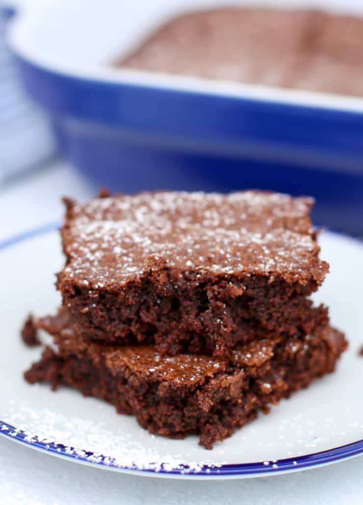 Brownies stacked up on a blue plate