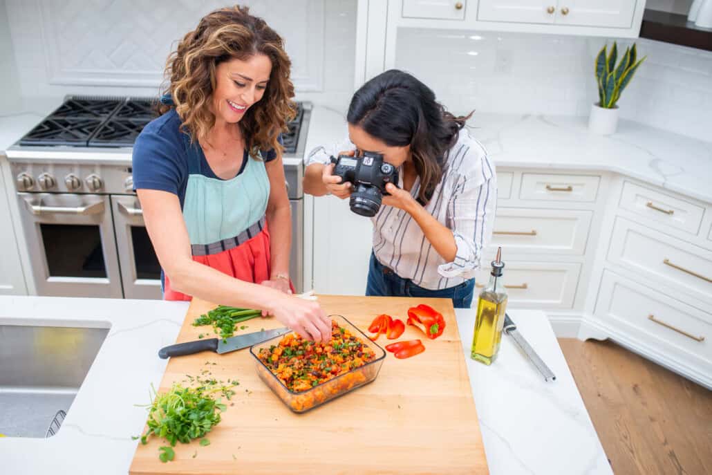 Rachel and Polly in kitchen taking photos