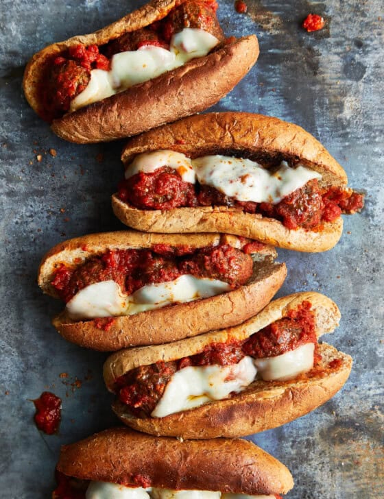 Meatball subs that have been under the broiler, side by side.