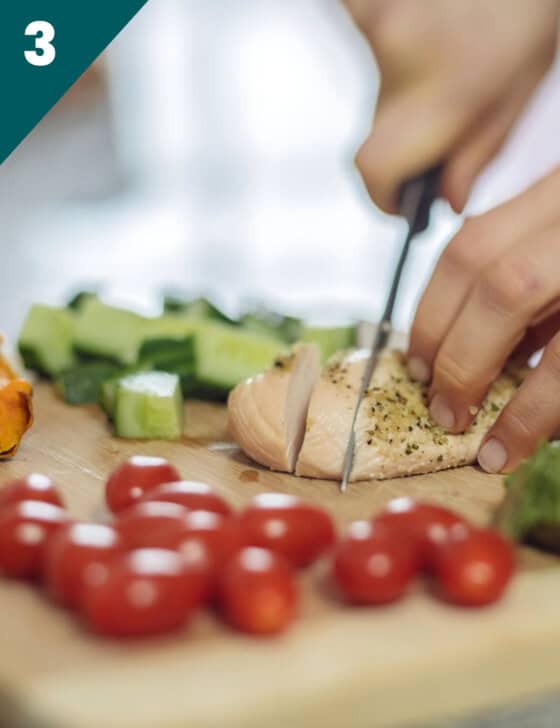 Someone cutting a chicken breast.