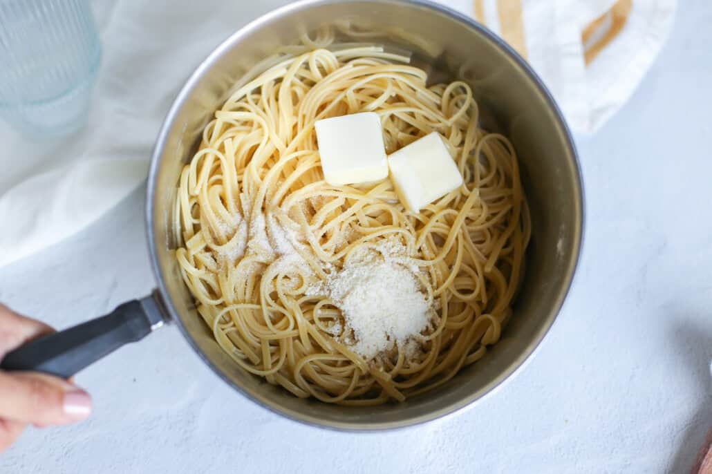 overhead shot of cooked noodles with butter and parmesan 
