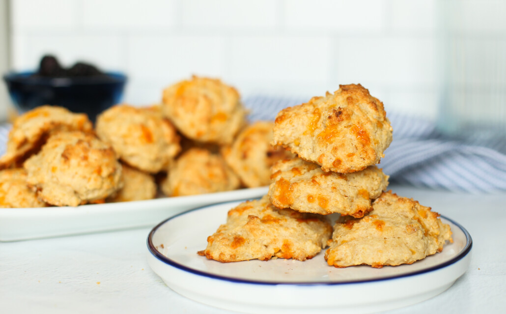 Cheddar biscuits stacked on a plate