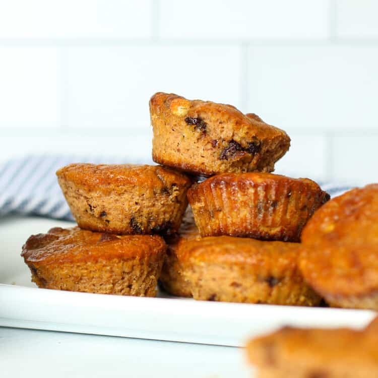 Gluten-free pumpkin muffins piled on a serving platter.