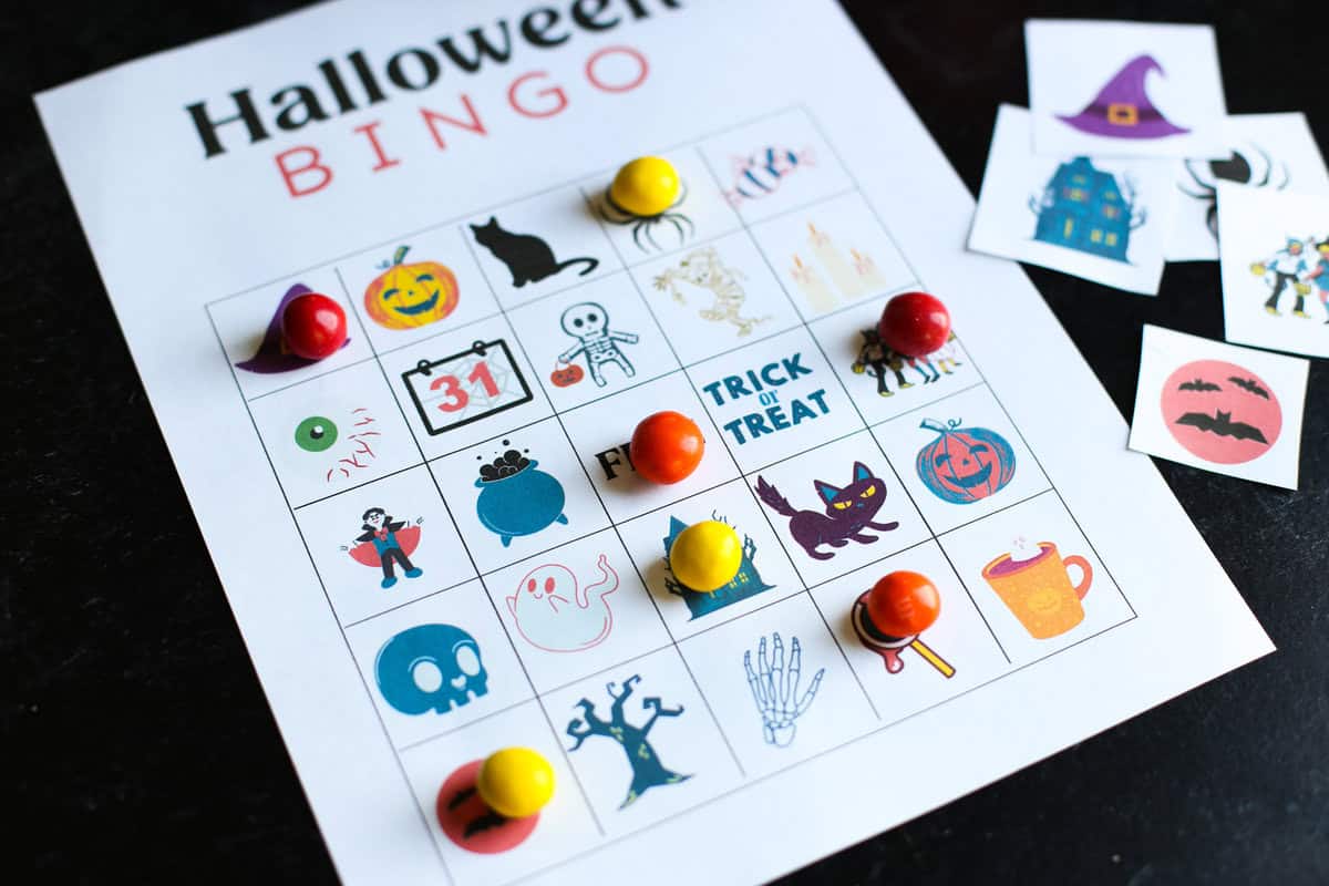 Halloween Bingo game card on a table with candy being used as markers.