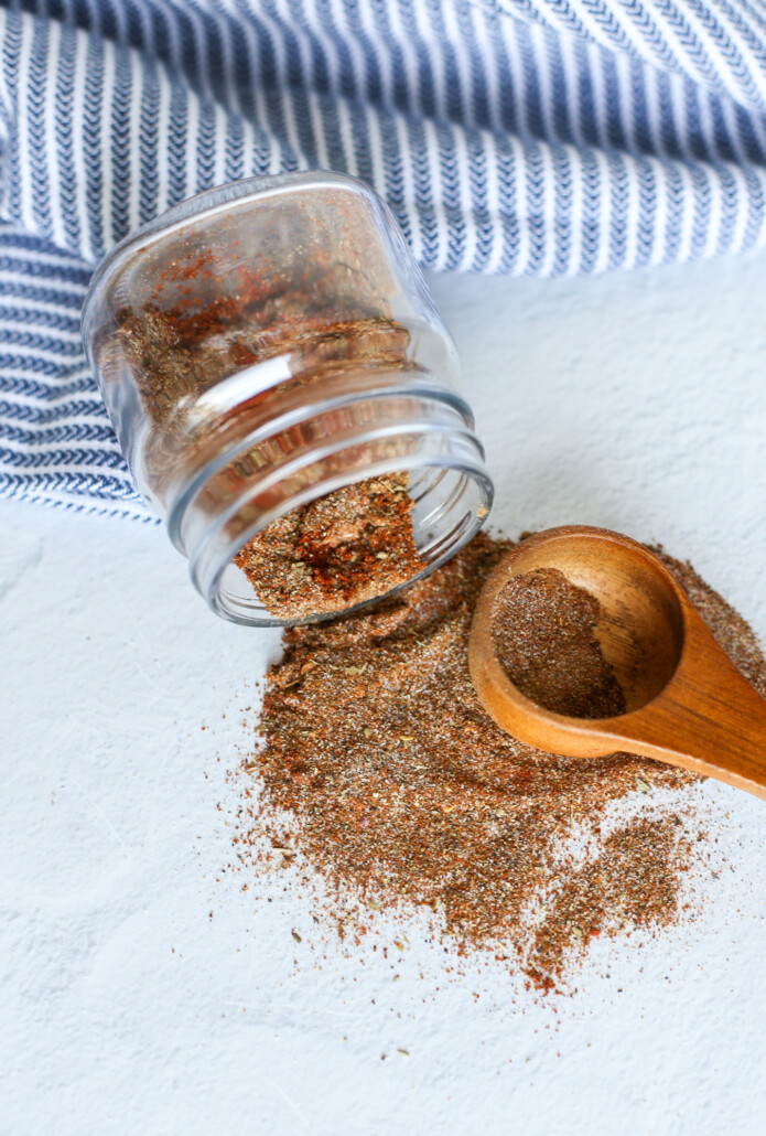Taco seasoning recipe spilled out of a jar