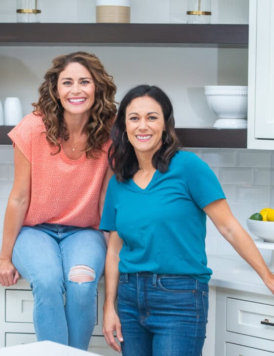 Polly and Rachel holding cookbooks.