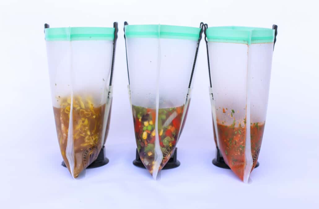 3 reusable freezer bags in baggy holders with food