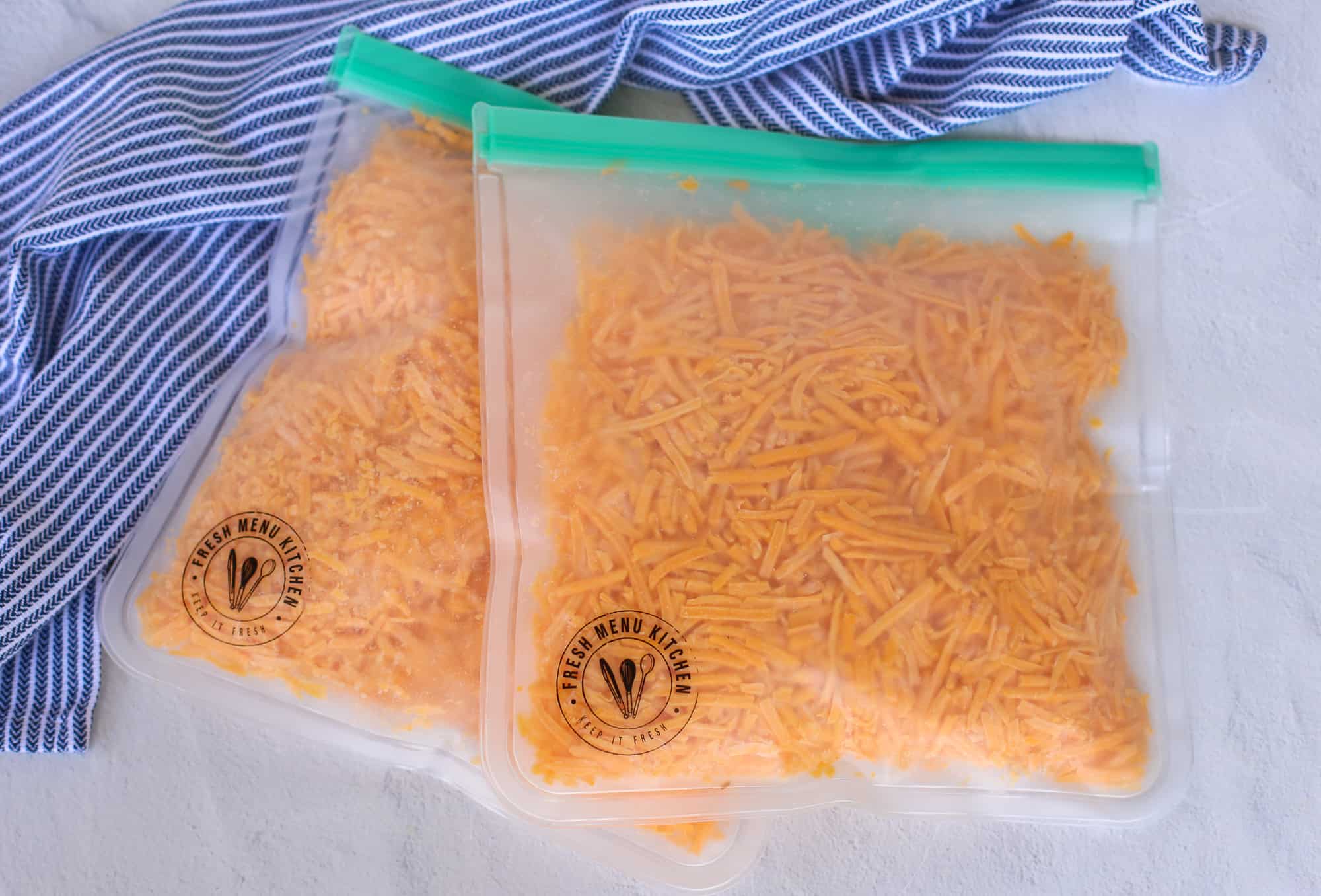 Two bags of frozen shedded cheese. 