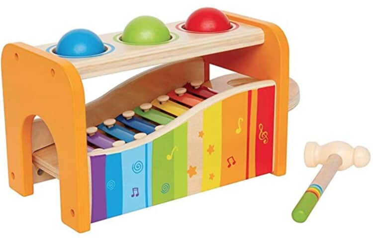 Wooden xylophone with a top over it that has three different color balls that can be hammered to fall and make music on the xylophone.