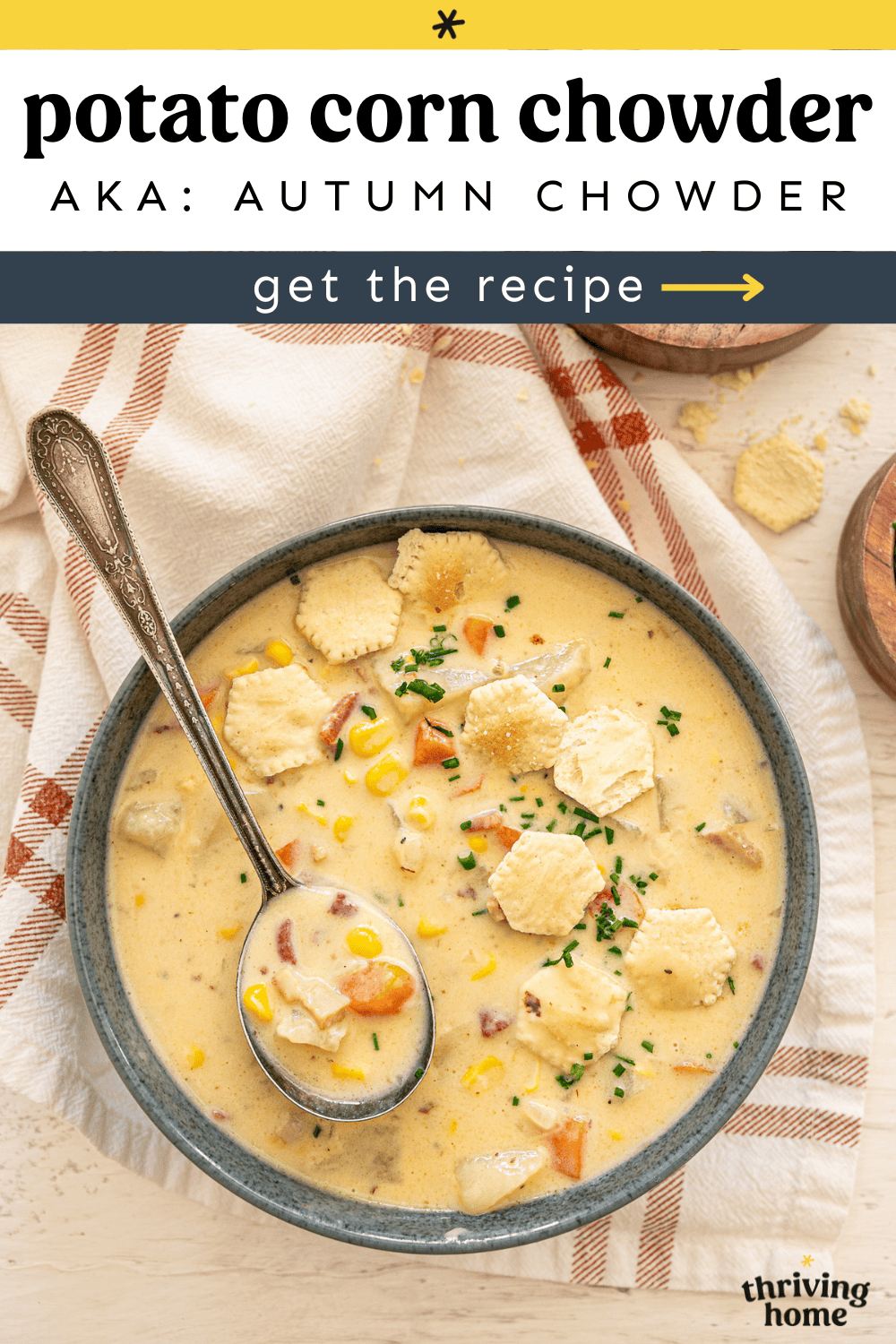 A bowl of potato corn chowder with oyster crackers on top.