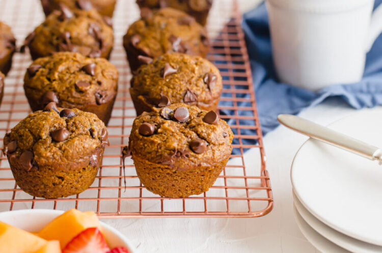 Pumpkin chocolate muffins on a cooling rack.