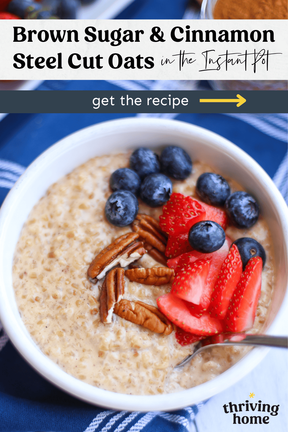 Bowl of steel cut oats with sliced strawberries and blueberries on top.