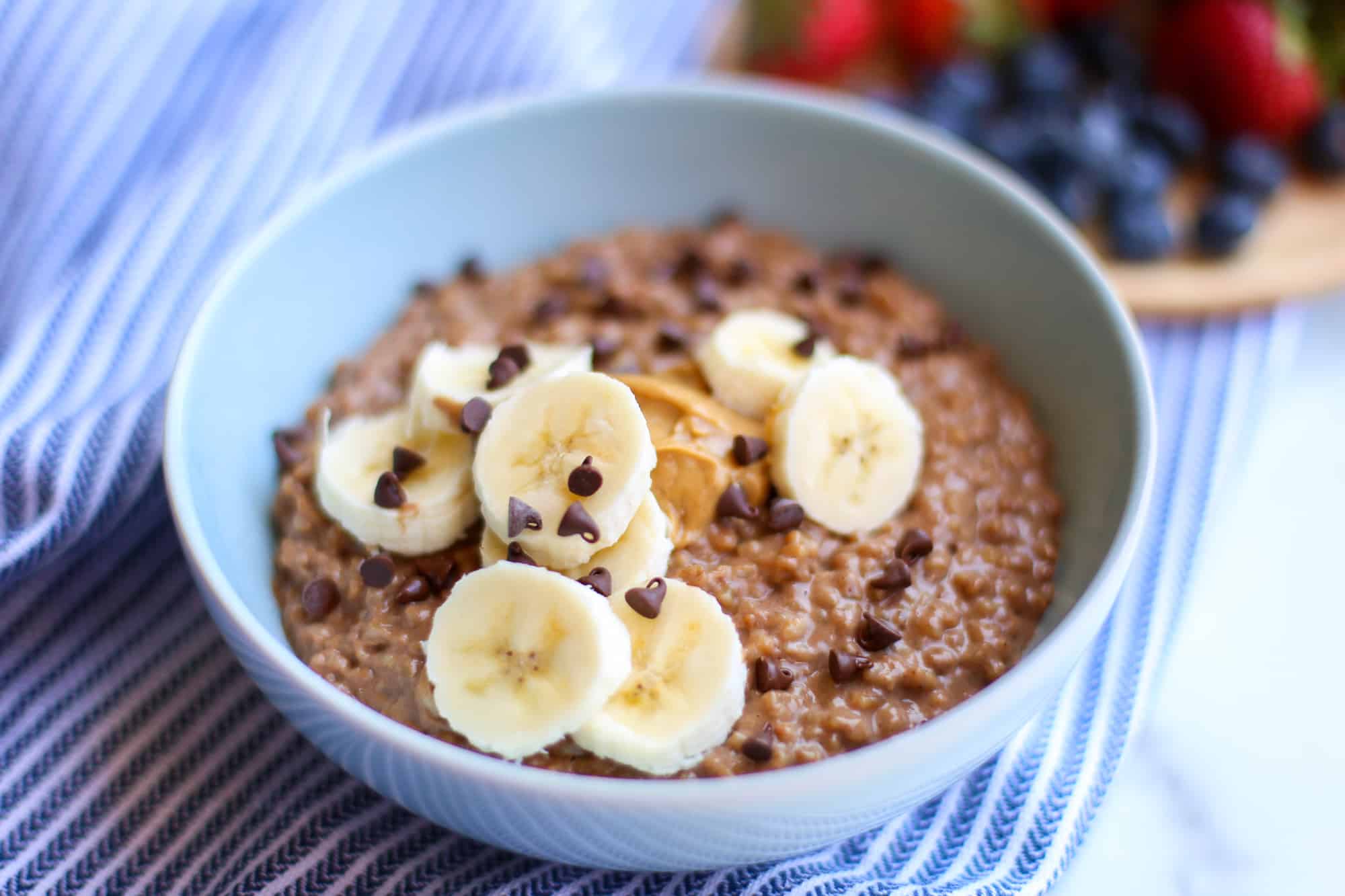 Instant Pot steel cut oatmeal topped with banana, peanut butter and chocolate chips.