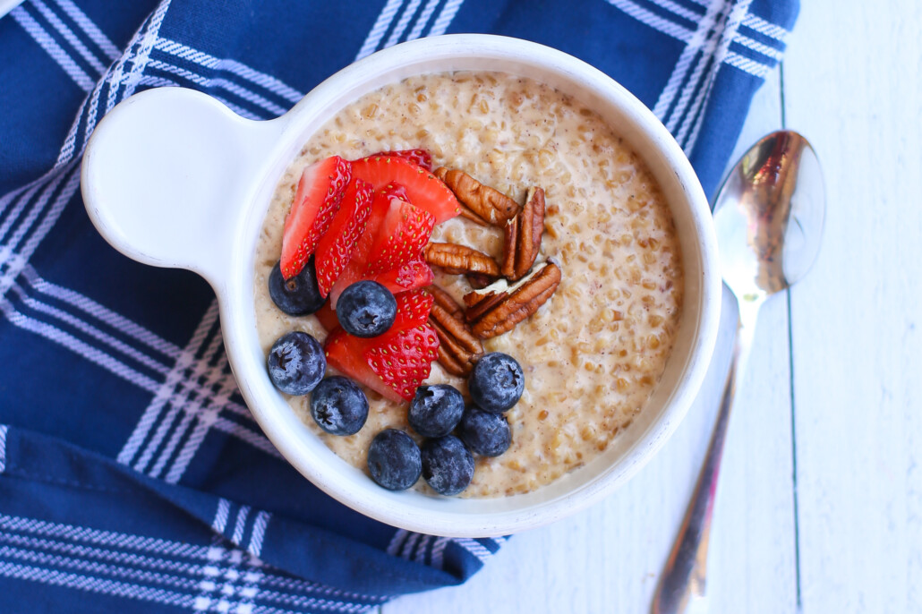 Overhead shot of steel cut oats with fruit and pecans as topping